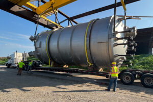 Indiana River & Rail Terminals staff carefully lowers a 51-ton, 44-foot by 18-foot tank onto a heavy-duty flatbed at Mount Vernon, Ind., July 28, 2025 .