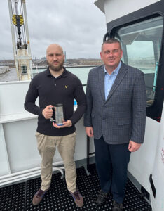 Burns Harbor Port Director Ryan McCoy (right) presents the Steel Stein to Capt. Ilia Kalachov on board the Ocean7 Ranger on April 4.